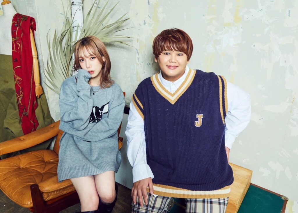 パパラピーズの宣材写真。タナカガさんとじんじんさんが椅子に座り、カジュアルな衣装でポーズを決めている